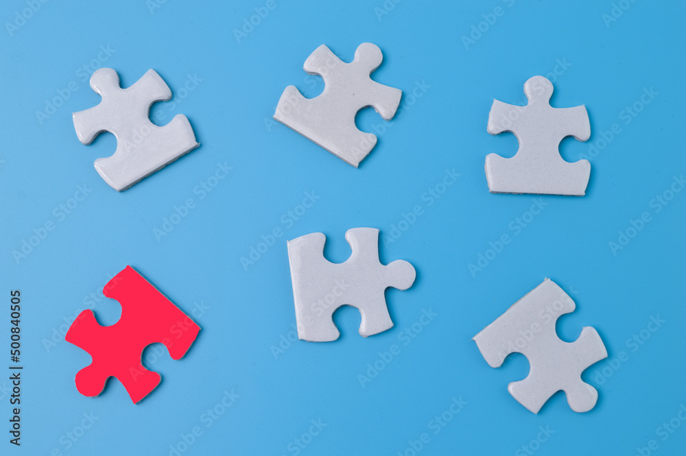 Unique red piece of puzzle among white puzzles. Society, social group, leadership qualities and talent concept Unique red piece of puzzle among white puzzles. Society, social group, leadership qualities and talent concept