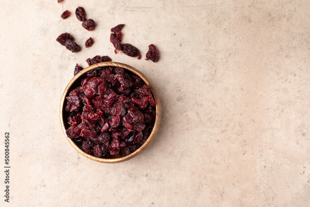 Healthy dried fruit, cranberry, prunes in a wooden bowl top view