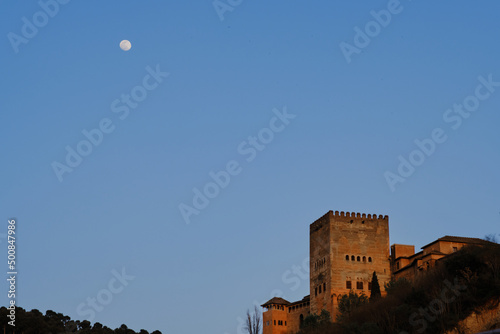 Full moon at sunset in the Comares Tower of La Alhambra, Granada