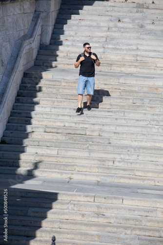 people walking by stone stairs with backpack © phpetrunina14