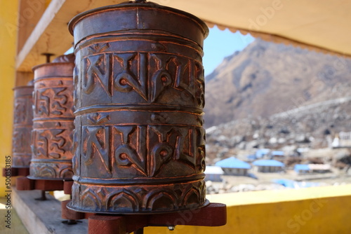 Tibetan prayer wheel by Langtang valley view, Nepal