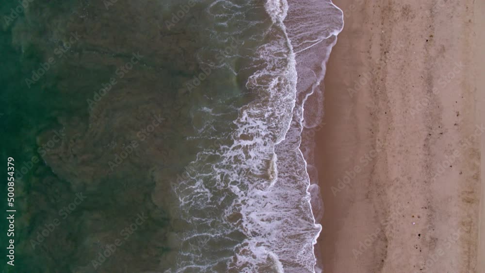 Aerial Top Forward Shot Of Sea Waves Splashing On Beach Landscape - Santa Monica, California Aerial Top Forward Shot Of Sea Waves Splashing On Beach Landscape - Santa Monica, California