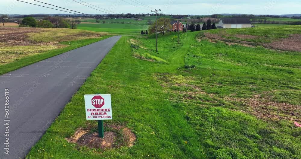 Biosecure area sign, No Trespassing. Agriculture farm site to stop spread of H5N1 Avian Bird Flu. Biosecurity stop virus spread. Aerial reveals large factory farm.