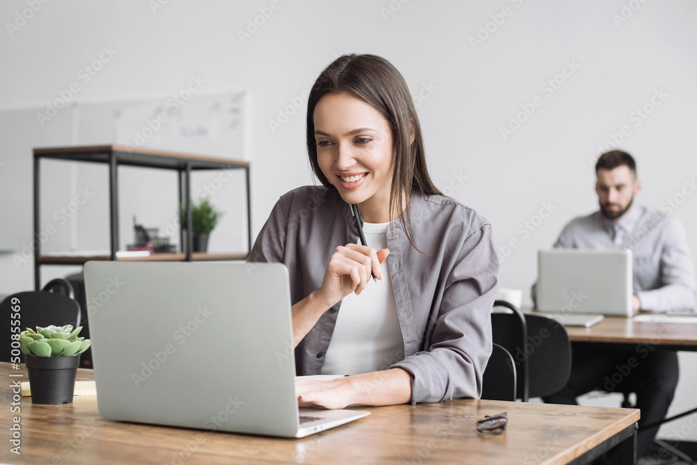 Young business woman using laptop computer at office. Student girl working at class. Colleagues using computers in co-working. Modern business lifestyle concept. Young business woman using laptop computer at office. Student girl working at class. Colleagues using computers in co-working. Modern business lifestyle concept.