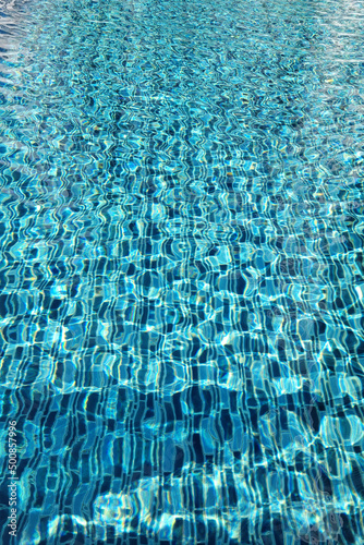 Blue ripped water an and mosaic tiles in swimming pool