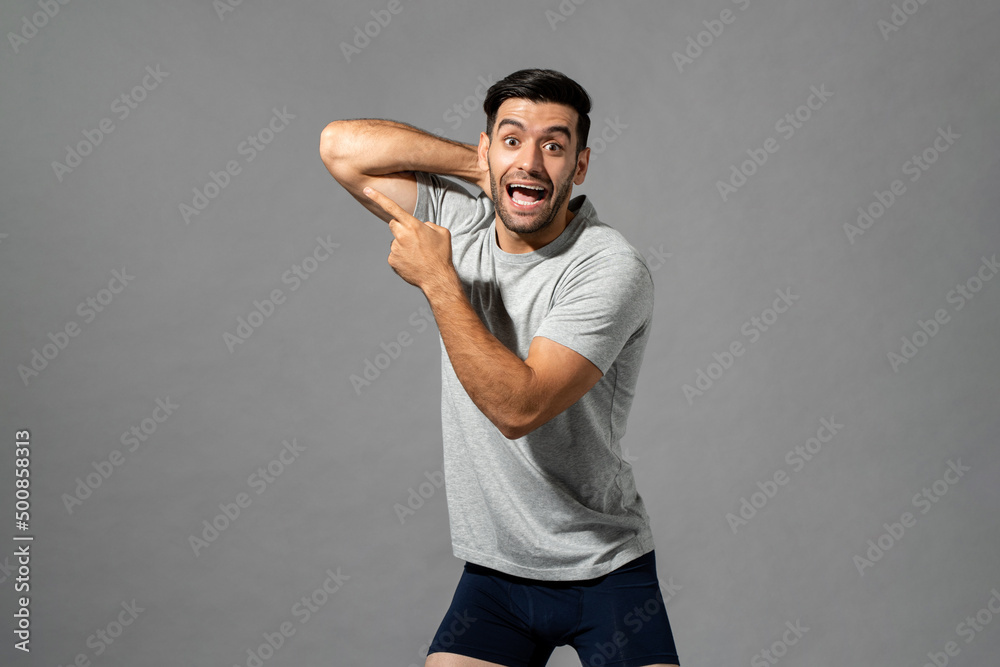 Positive Caucasian man in sleepwear pointing away