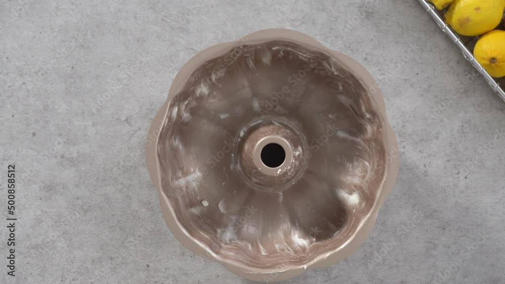 Flat lay. Step by step. Greasing bundt cake pan to bake lemon cranberry bundt cake. Flat lay. Step by step. Greasing bundt cake pan to bake lemon cranberry bundt cake.