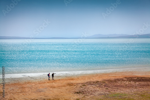Tourists walks on the shore of Styfe Golu solt lake. Beautiful morning scene of Turkey, Asia. Traveling concept background..