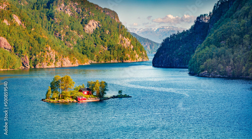 Superb summer view of Lovrafjorden flord with small island and typical Norwegian building, North sea. Splendid morning view in Norway. Beauty of nature concept background.