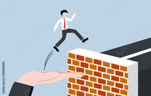 Business supporting overcome difficulties or obstacles, motivating and encouraging employee to succeed, mentorship concept. Big boss hand helping businessman jump over roadblock to elevated highway.