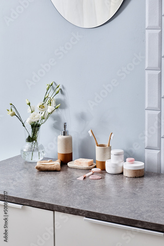 Vertical image of table in modern bathroom with female toiletries and cosmetics Fototapet