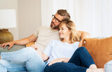 Happy couple relaxing on the couch at home