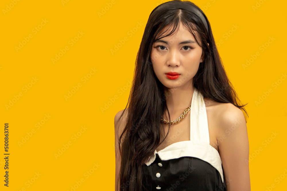 Fashion concept, Fashionable woman posing in a mini dress isolated yellow background in studio Fashion concept, Fashionable woman posing in a mini dress isolated yellow background in studio
