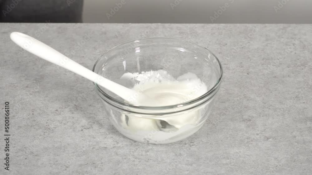 Step by step. Mixing ingredients in a glass mixing bowl to prepare the white glaze. Step by step. Mixing ingredients in a glass mixing bowl to prepare the white glaze.