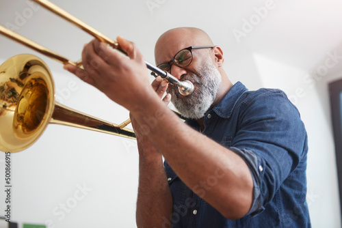 Portrait of man playing trombone photo