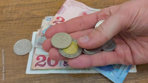 Georgian lari coins in man hand.