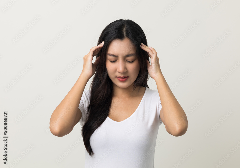 Young asian beautiful woman hand touching head she's feeling depressed stress headache be tired from working standing on isolated white background she has symptom office syndrome. Young asian beautiful woman hand touching head she's feeling depressed stress headache be tired from working standing on isolated white background she has symptom office syndrome.