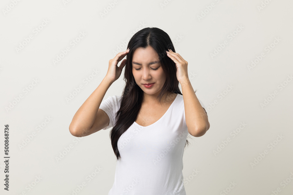 Young asian beautiful woman hand touching head she's feeling depressed stress headache be tired from working standing on isolated white background she has symptom office syndrome. Young asian beautiful woman hand touching head she's feeling depressed stress headache be tired from working standing on isolated white background she has symptom office syndrome.