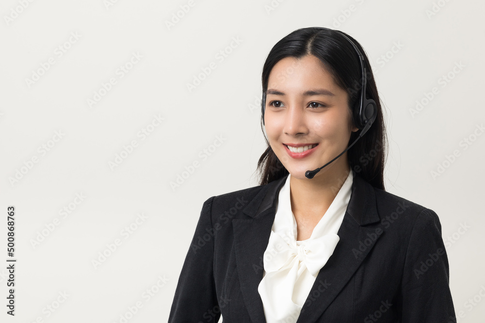 Happy young asian business woman call centre. Welcome female operator put on smalltalk headphone standing on isolated white background. Happy young asian business woman call centre. Welcome female operator put on smalltalk headphone standing on isolated white background.