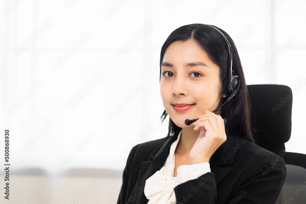 Call centre female operator. Smiling asian business woman receptionist wearing headphone video conference calling talk by webcam in online chat customer support service. Call centre female operator. Smiling asian business woman receptionist wearing headphone video conference calling talk by webcam in online chat customer support service.