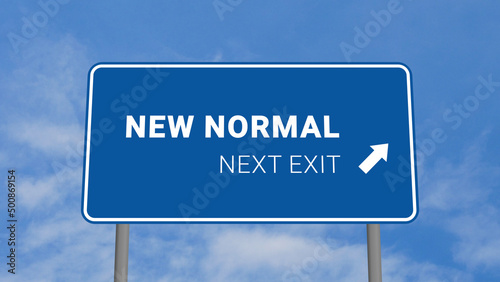 Next Exit is New Normal Road Sign on Clear Blue Sky with Rapid Moving Clouds photo