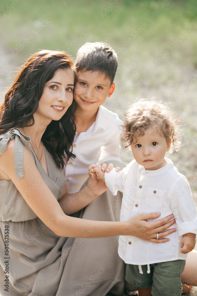 Happy young woman with children on wheat summer field. Happy motherhood. Happy young woman with children on wheat summer field. Happy motherhood.