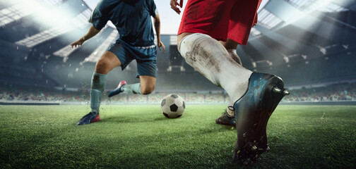Cropped image of two soccer, football players in motion, action at stadium during football match. Concept of sport, competition, goals