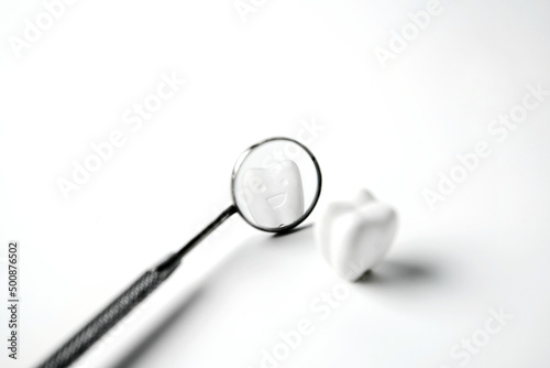 Selected focus smile and whitening tooth reflect on mirror mouth on white background, healthy dental and smile confident 