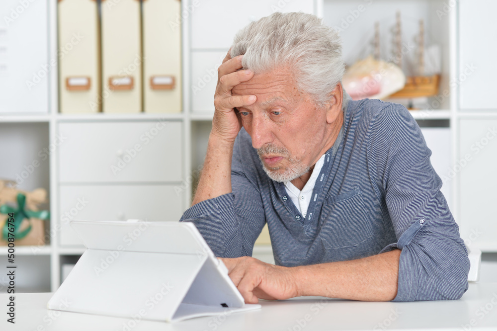 senior man with tablet computer at home senior man with tablet computer at home