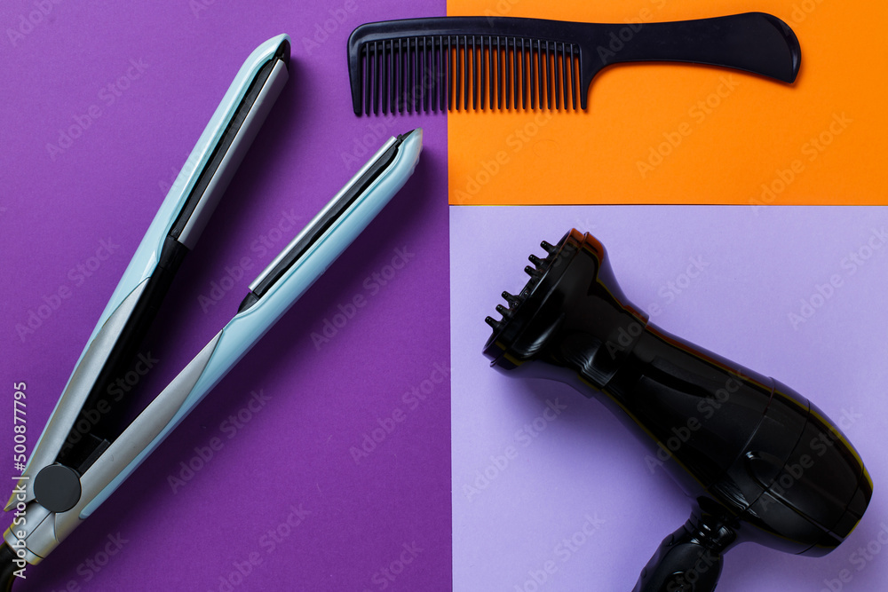 comb, hair dryer and hair straighteners lie on a bright background. Fashionable bright trendy colors. stylist equipment. comb, hair dryer and hair straighteners lie on a bright background. Fashionable bright trendy colors. stylist equipment.