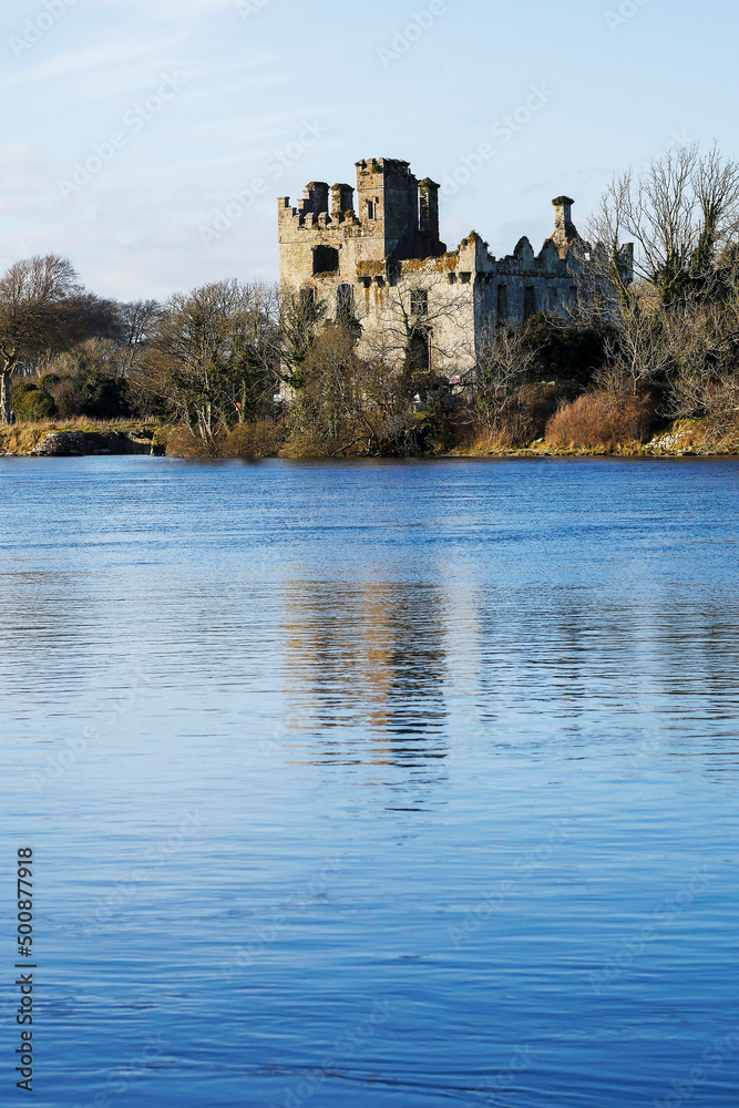 River Corrib, Galway city, Ruins of Melnlo castle in the background. Blue cloudy sky and reflection in water. Nobody