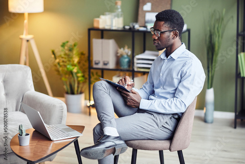 Serioius young therapist asking client to give more details about his concerns in online therapy session