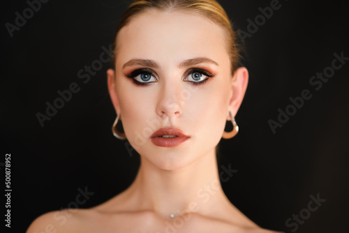Beauty portrait of young woman with smoky eyes makeup.