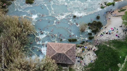 Europe, Drone aerial view of natural Spa and Thermal Springs of Saturnia, Grosseto, Tuscany, Italy. Unrecognizable Tourists Taking Healthy Bath in Hot Springs Waterfall. Relax and Spa Concept photo