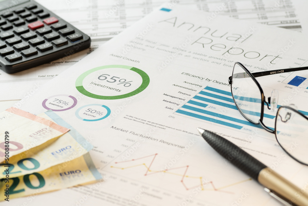 Mockup financial charts report sheet with visible pen, calculator, eyeglasses and euro banknotes. Accounting, business, finance, tax and office concepts. Mockup financial charts report sheet with visible pen, calculator, eyeglasses and euro banknotes. Accounting, business, finance, tax and office concepts.