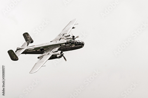 Vintage photo of silver WW2 bomber aircraft isolated on white