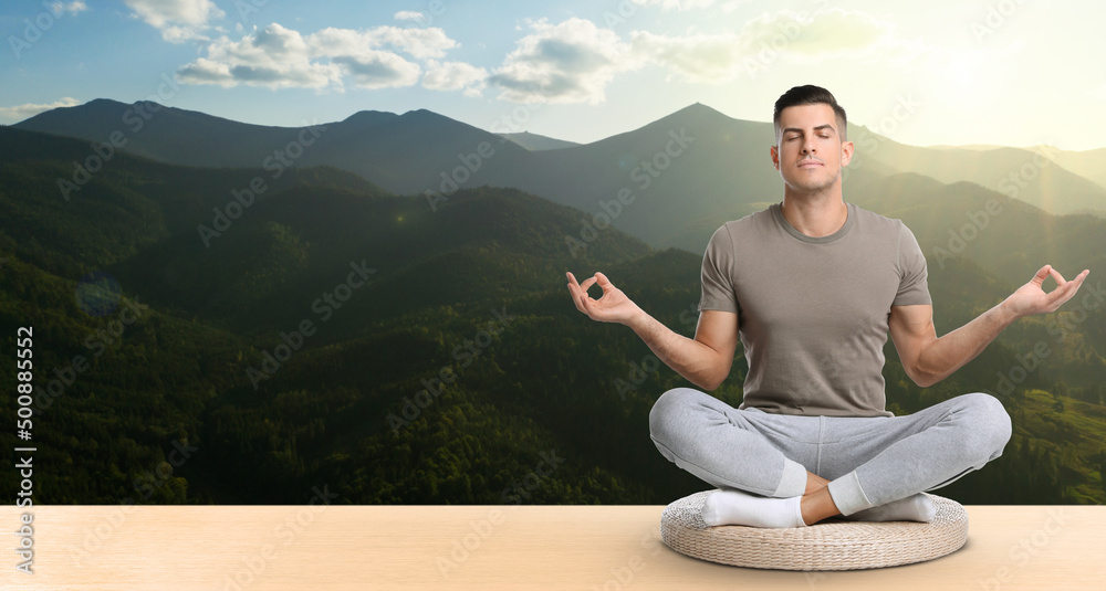 Man practicing yoga on wooden surface against beautiful mountain landscape, space for text. Banner design
