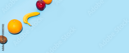Fresh fruits on a blue background. Top view, flat lay. Banner.