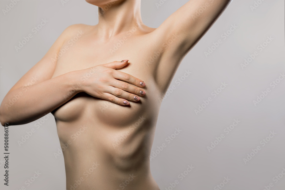 Beautiful girl with a beautiful body. Woman with breast pain touching chest.  Female healthcare concept. Stock Photo