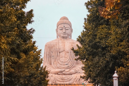 Photograph of 80 feet statue of buddha against the sky  photo