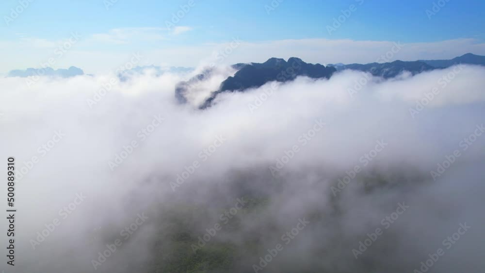 4K aerial view from a drone flying over the valley, fog in the morning. bright weather and amazing nature landscape. Khao sok National Park, Surat Thani, Thailand. 4K
4K aerial view from a drone flying over the valley, fog in the morning. bright weather and amazing nature landscape. Khao sok National Park, Surat Thani, Thailand. 4K