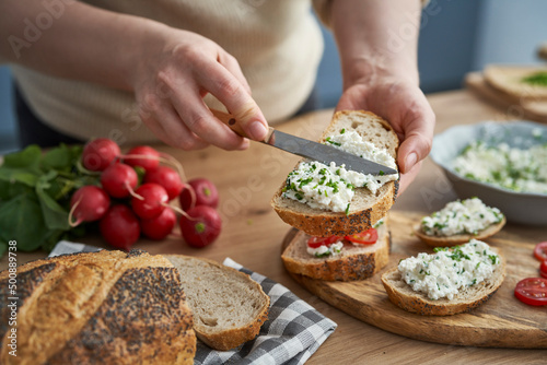 Woman making preparing sandwich of cottage cheese