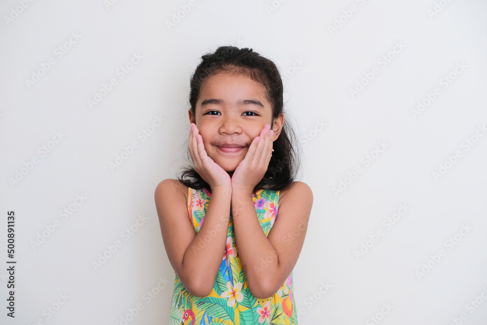 Asian kid girl smiling happy with both hand on her chin Asian kid girl smiling happy with both hand on her chin