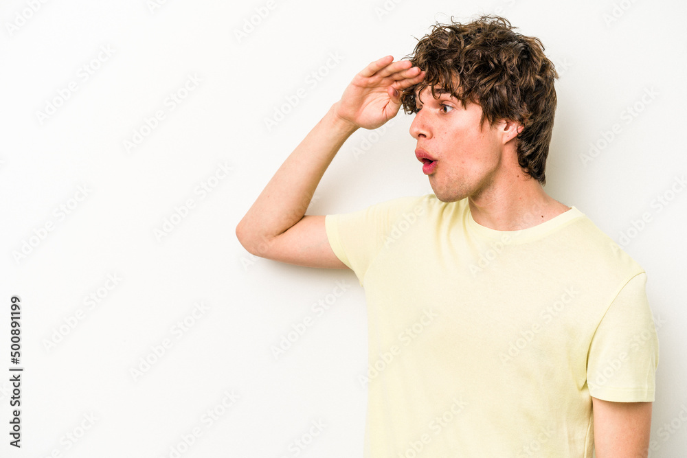 Young caucasian man isolated on white background looking far away keeping hand on forehead. Young caucasian man isolated on white background looking far away keeping hand on forehead.