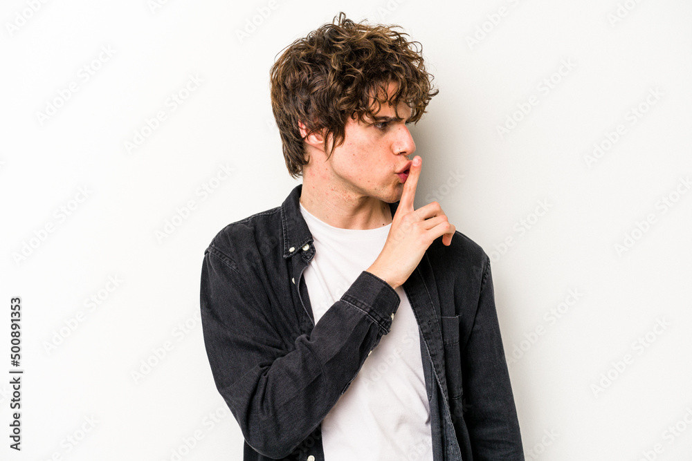 Young caucasian man isolated on white background keeping a secret or asking for silence. Young caucasian man isolated on white background keeping a secret or asking for silence.