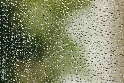 The relaxing raindrops is flowing down the window.