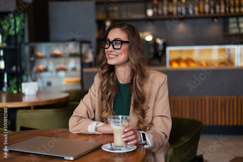 Business Woman Restaurant Owner Use Laptop In Hands Dressed Elegant Pantsuit Sitting Table In Restaurant With Bar Counter Background