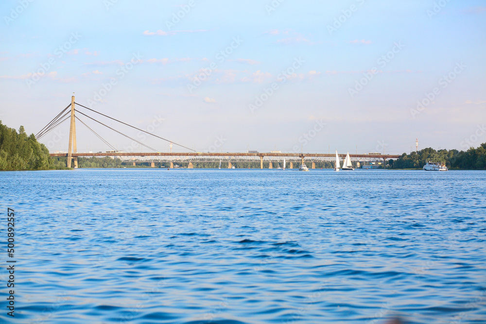Banner with a beautiful cityscape, a view of the river and the bridge. Summer. Europe, Kyiv. Skyline. Travel concept. Banner with a beautiful cityscape, a view of the river and the bridge. Summer. Europe, Kyiv. Skyline. Travel concept.