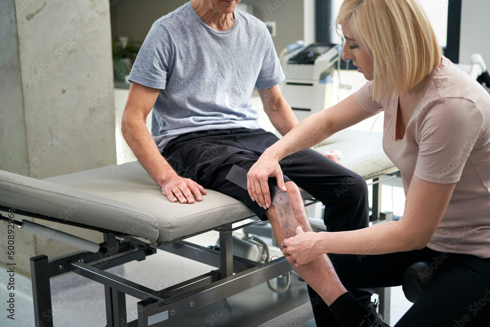 Close up of female physical therapist working with her patient Close up of female physical therapist working with her patient
