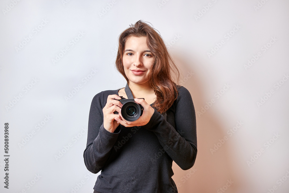 Beautiful girl takes pictures with a digital camera. Beautiful girl takes pictures with a digital camera.
